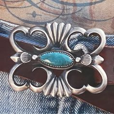 Double D Ranch “ Dennehotso” Belt & Buckle Is A Gorgeous Vintage Piece That Will Continue To Add That Finishing Touch To Your Wardrobe. It Starts On A Vintage Leather Belt That Is A Deep Brown Color. As For The Buckle, It Is A Vintage Cast Sterling Silver Buckle With A Bezel-Set Turquoise Stone In The Center. This Bold Buckle Adds That Perfect Creative Touch. Materials: Sterling Silver, Turquoise, Vintage Leather Strap Measurements: Buckle: 3” X 2 1/4”. 1” Wide Strap Fits 34” To 39” (5 Pre- Punc Western Style Blue Concho Belt Buckles, Blue Concho Western Belt Buckles, Navajo Belt, Vintage Adjustable Turquoise Belt, Adjustable Turquoise Vintage Belt, Turquoise Belt Buckle, Turquoise Belt, Double D Ranch, Vintage Leather Belts