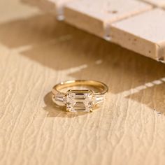 an engagement ring sitting on top of a wooden table