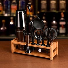 an assortment of kitchen utensils are displayed on a wooden tray with the words make a beautiful bar display