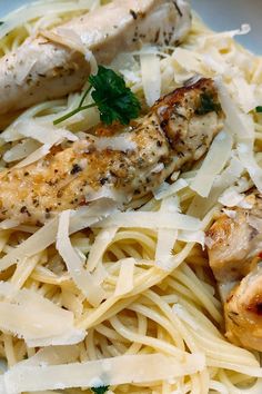 pasta with chicken and parmesan cheese in a white bowl