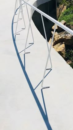 a skateboarder is doing a trick in the air on a ramp near some rocks