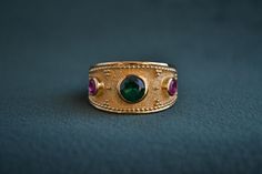 A byzantine ring made with solid Sterling Silver (925 Silver), that has a 22K Gold-plating. The stone in the center of the ring is a Cubic Zirconia Emerald, and the ones on the sides are CZ Rubies. Contact us for alternative options on the stones. Byzantine Ring, Medieval Ring, Byzantine Rings, Medieval Rings, 22k Gold, Artisan Jewelry, Gold Plating, Silver 925, The Stone