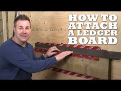 a man standing next to a wooden board holding a large piece of wood with the words how to attach a ledge board on it