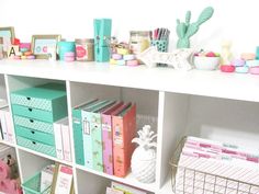 a white shelf filled with lots of colorful boxes