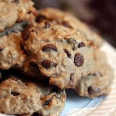 chocolate chip cookies stacked on top of each other in a white and brown plate with a blue edge