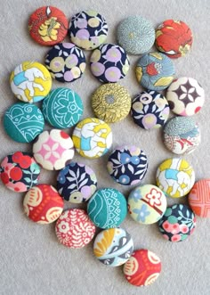 several different types of buttons sitting on top of a table