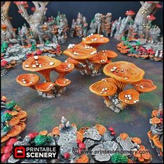 a group of wooden mushrooms sitting on top of a table covered in leaves and rocks