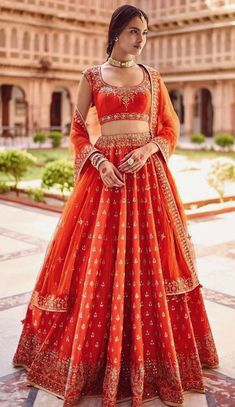 a woman in an orange lehenga