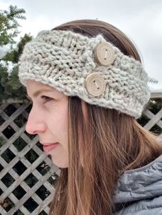 a woman wearing a knitted headband with buttons on the front and back of her head