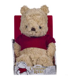 a brown teddy bear sitting in a red chair next to an ebay coupon