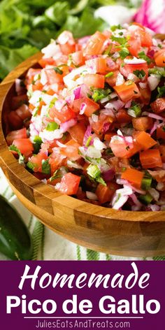 a wooden bowl filled with diced tomatoes, onions and cilantro on top of a table