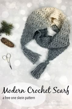 the modern crochet scarf is shown with scissors, pine cones and other items