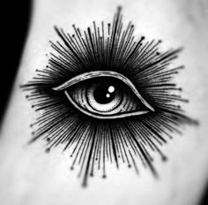 an all seeing eye tattoo on the back of a woman's right leg,