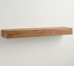 a wooden shelf mounted on the wall