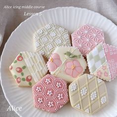 a white plate topped with lots of decorated cookies