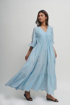 Experience freedom in our loose, tiered boho dress made from 100% organic cotton.  The V-neck combined with the tiered skirt and intricate pleated detailing makes it perfect for beach strolls and summer dinners.  Features two inseam pockets and customizable colour options.  Length: 51 inches.  Quality: 60's Organic Cotton.  Care: Hand wash with light detergent or dry clean.  Ships within 3-5 business days. For quicker delivery please send us a message. Additional Information: Colour: City Sky Bl City Sky, Layered Dress, Gathered Sleeves, Linen Maxi Dress, Boho Tunics, Dress Boho