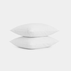 two white pillows stacked on top of each other