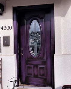 a purple front door with a glass window