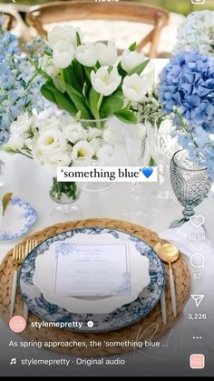 a table set with blue and white flowers