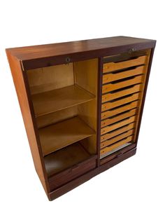 a wooden cabinet with drawers and shelves on one side, open to reveal the contents