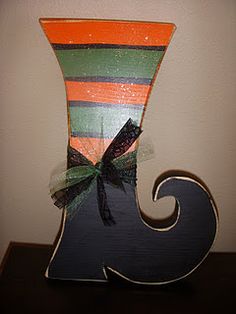 an orange and black striped vase with a bow