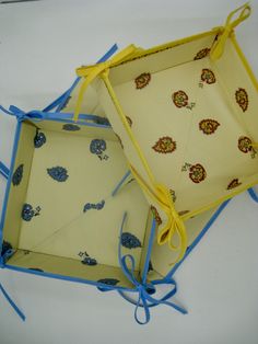 two open boxes with blue and yellow designs on them