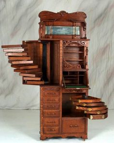 an old fashioned wooden desk with drawers and other items in front of it on a white background