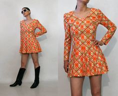 "vintage '70s tangerine & cream flirty geo mini dress check / harlequin geo pattern puffed shoulders fit 'n' flare / skater shape zips up the back unlined DETAILS-----> Era: '70s Fabric: MEASUREMENTS-----> Tag: n/a - no size marked; should fit a modern xs - small **has a bit of stretch - about 1\" Shoulders: 14.25\" Bust: 16.25\" Sleeves: 23.5\" Sleeves (from underarm): 17.25\" Waist: 14\" Hips: free Length: 30.25\" CONDITION-----> In excellent vintage condition. No flaws to note. MODEL SPECS--- 70s Twist Front Dress, 70s Mini Dress Cocktail, V Neck 70s Dress, Cheap Retro Mini Dress, 70s Cutout Dress, 1970 Short Dress, 70’s Dresses, 70s Mini Dress, 70's Dress