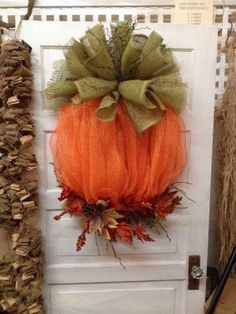 an orange and green pumpkin hanging on a door with the words crafty corner added a new photo