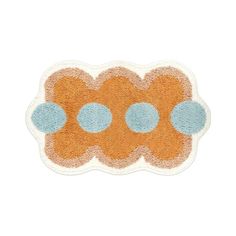 an orange and blue rug with circles on the top, in front of a white background