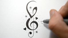 someone is drawing music notes on paper