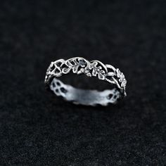 This sterling silver oak leaf vine ring captures the beauty of nature with a delicate design featuring intertwined oak leaves encircling the band. The detailed knotwork and natural elements represent growth, strength, and harmony. Perfect for those who love Celtic, woodland, and fantasy-inspired jewelry, this ring's timeless elegance makes it ideal for weddings, special occasions, or everyday wear. Handcrafted with care, the ring is oxidized to enhance the intricate oak leaves and vine details, Elven Wedding, Vine Ring, Silver Oak, Engagement Band, Botanical Jewelry, Oak Leaves, Unique Wedding Bands, Delicate Design, Oak Leaf