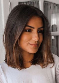 a close up of a person wearing a white t - shirt and looking at the camera