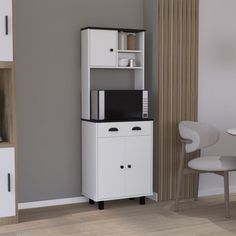 a white cabinet sitting next to a table with a microwave on it's top