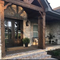 the front entrance to a home with brick steps