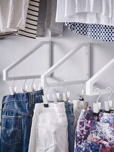 several pairs of shorts hanging on clothes racks