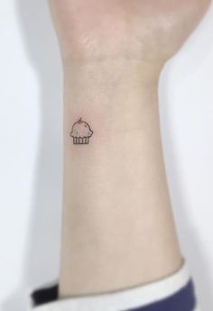 a small cupcake tattoo on the wrist