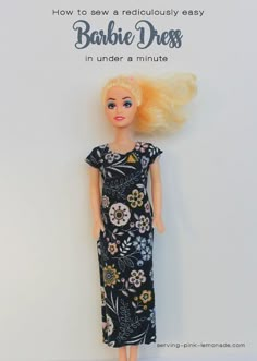 a barbie doll with blonde hair wearing a black dress