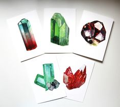 four cards with different colored crystals on them