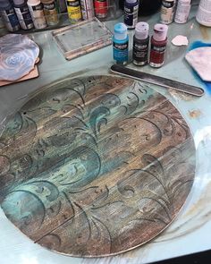 a table topped with lots of crafting supplies on top of a metal countertop