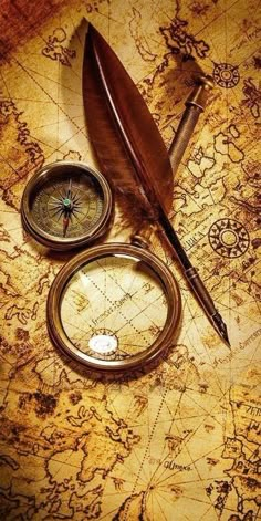 an old map with a compass, magnifying glass and a feather quill