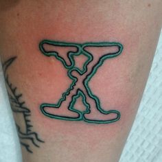 a tattoo with the letter x on it