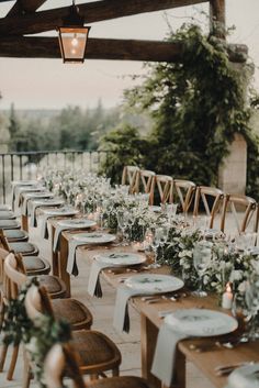 an outdoor dining area with tables and chairs set up for a formal dinner or party