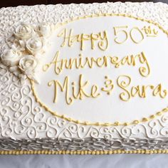 a 50th wedding anniversary cake with white and gold frosting