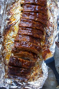 the meat is cooked and ready to be eaten on the foil lined grilling sheet