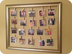 a photo frame with pictures pinned to clothes pins on a string attached to the wall