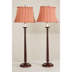 two lamps with red and white striped shades on each lamp, one is turned off