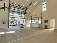 an empty basketball court in a building with lots of windows on the side of it