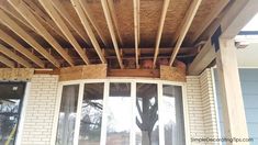 an unfinished roof is being installed on a home's front porch with wood framing