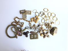 This listing contains a variety of vintage jewelry components, likely from the 1940's.  They are sold together as one lot, which features: 3 brass buckles with raised floral details.  Each meaures approximately 1 inch wide by 1 1/2 inch high. Brass ladder chain necklace with floral slider pendant.  Necklace measures 16 inches with lobster clasp. 2 brass cable chain bracelets with spring ring clasps and costume drop pearl embellishment.  Each bracelet measures 8 inches in length. Various brass beads and findings. All pieces listed in our Etsy shop have come out of a jewelry collector's studio and workshop who has been acquiring antique and vintage pieces for over 20 years. PLEASE NOTE:  This is a studio liquidation sale--all pieces are priced accordingly--therefore, all sales are final.  If Pearl Embellishment, Chain Bracelets, Brass Buckle, Brass Jewelry, Cable Chain, Spring Rings, Vintage Brass, Chain Bracelet, Lobster Clasp